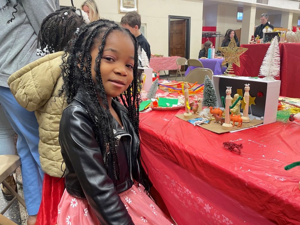 Girl making a nativity scene out of art supplies